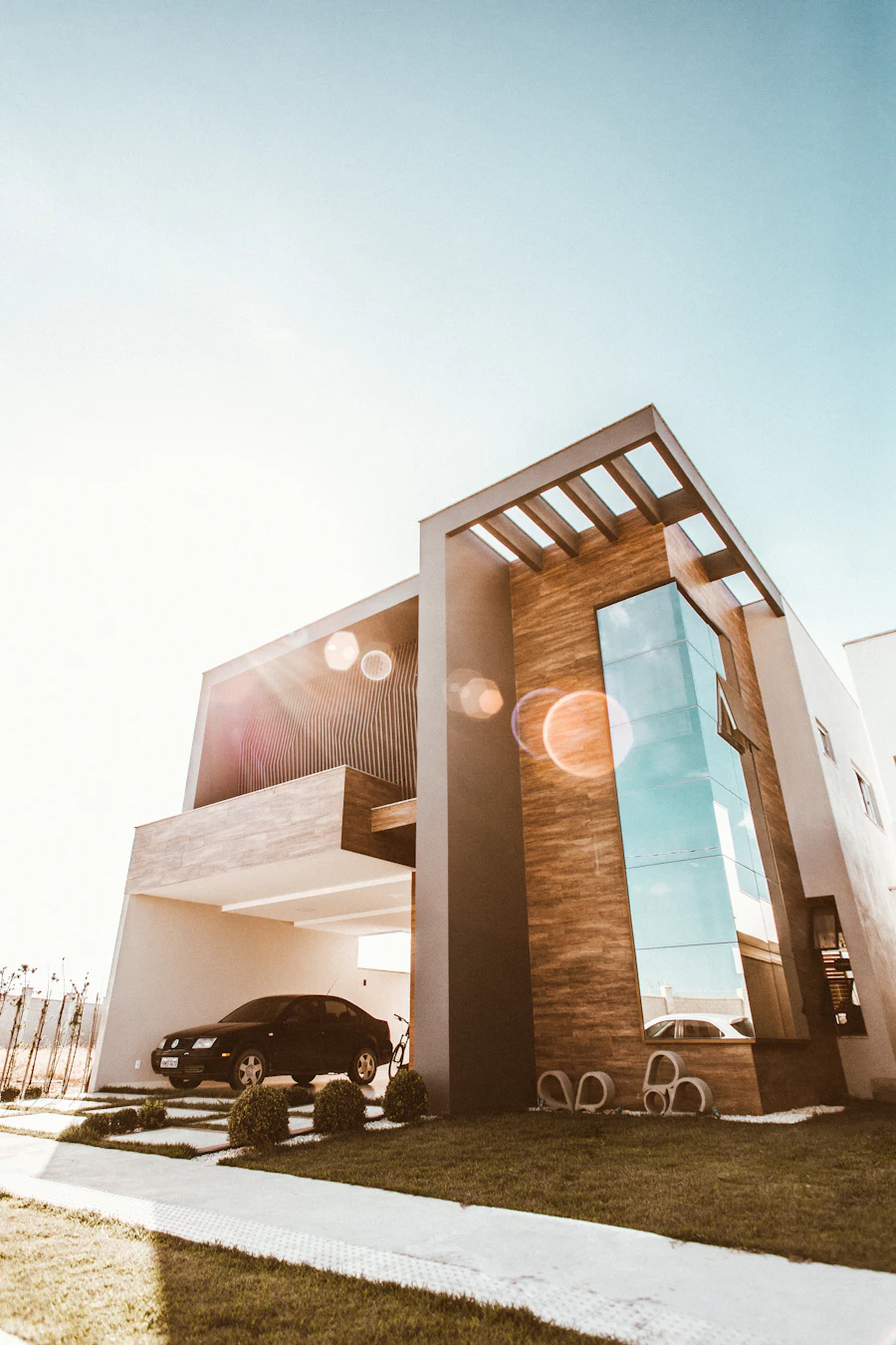 Angular modern house with a tall glazed entrance and timber accents
