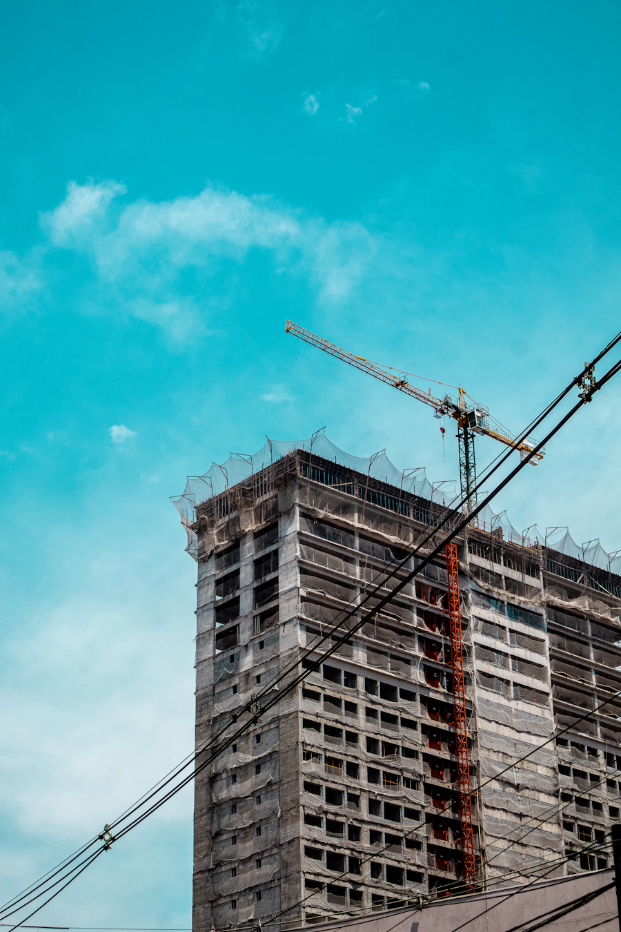 Tower crane beside a rising concrete building
